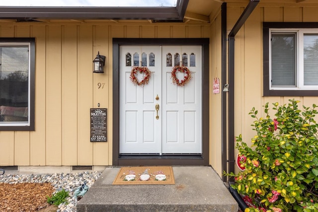 property entrance featuring crawl space and board and batten siding