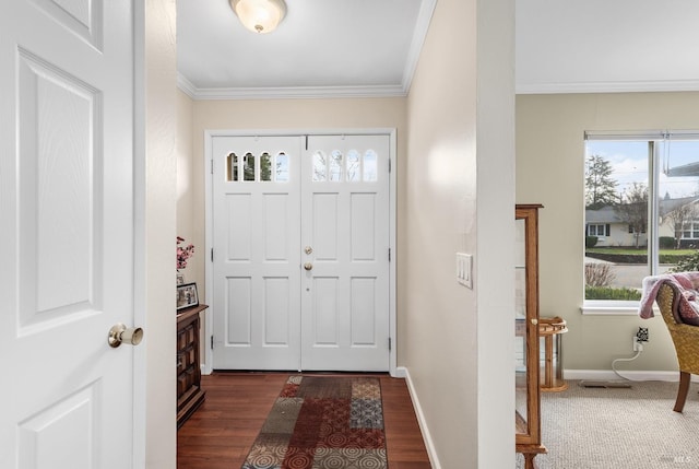 foyer with dark wood-style flooring, ornamental molding, and baseboards
