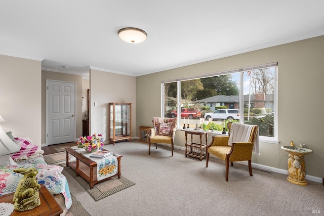 carpeted living room with baseboards and crown molding