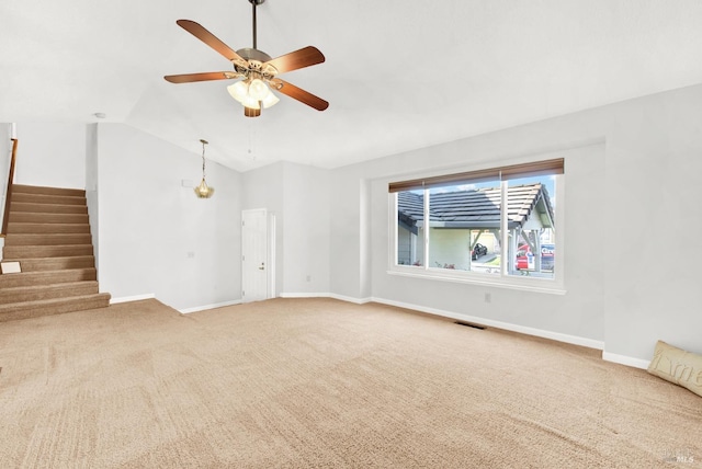 unfurnished living room featuring vaulted ceiling, carpet, and ceiling fan