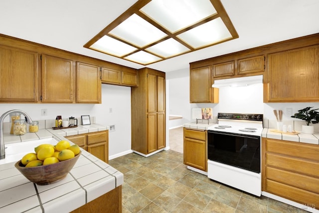 kitchen featuring tile counters and range with electric cooktop