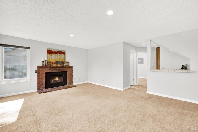 unfurnished living room featuring light carpet, a brick fireplace, and a textured ceiling