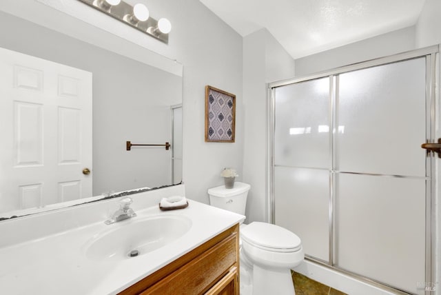 bathroom with walk in shower, vanity, and toilet