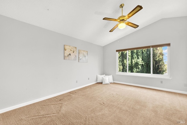 carpeted empty room with vaulted ceiling and ceiling fan