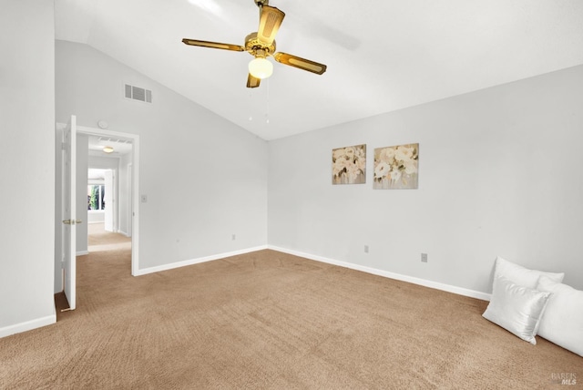 spare room featuring lofted ceiling, carpet floors, and ceiling fan