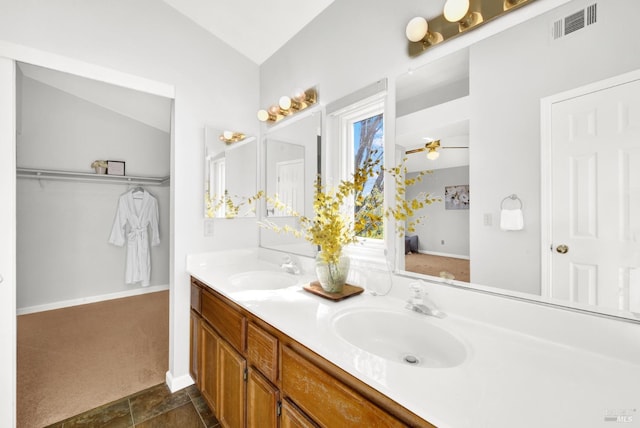 bathroom featuring ceiling fan, lofted ceiling, and vanity