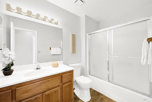 full bathroom with vanity, enclosed tub / shower combo, and toilet