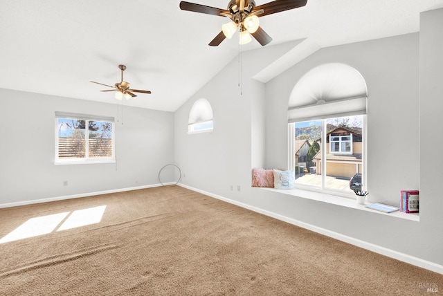 unfurnished room with lofted ceiling, plenty of natural light, carpet, and ceiling fan