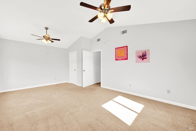 carpeted spare room featuring ceiling fan and high vaulted ceiling