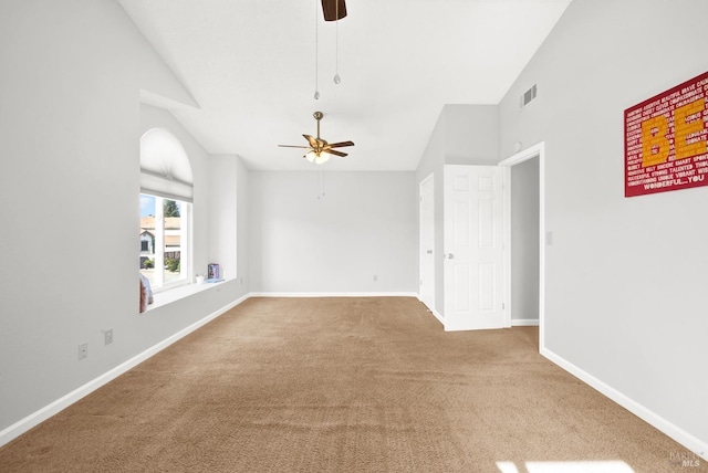 carpeted empty room with ceiling fan and lofted ceiling