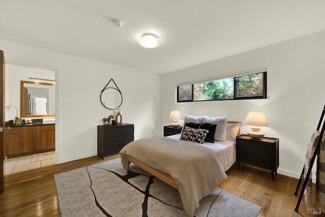 bedroom with baseboards and light wood-style floors