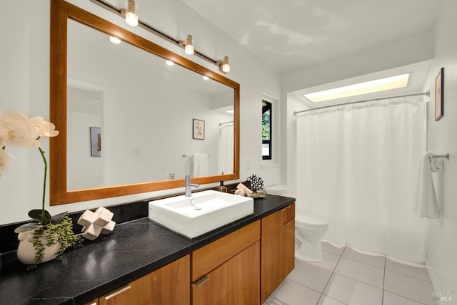 bathroom with a shower with curtain, vanity, tile patterned flooring, and toilet