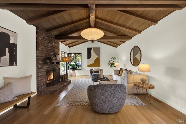 living area featuring wooden ceiling, wood finished floors, vaulted ceiling with beams, and a fireplace