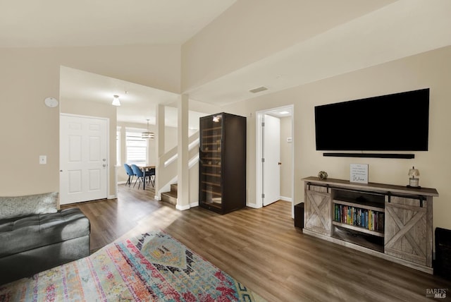 living room featuring dark hardwood / wood-style floors and lofted ceiling