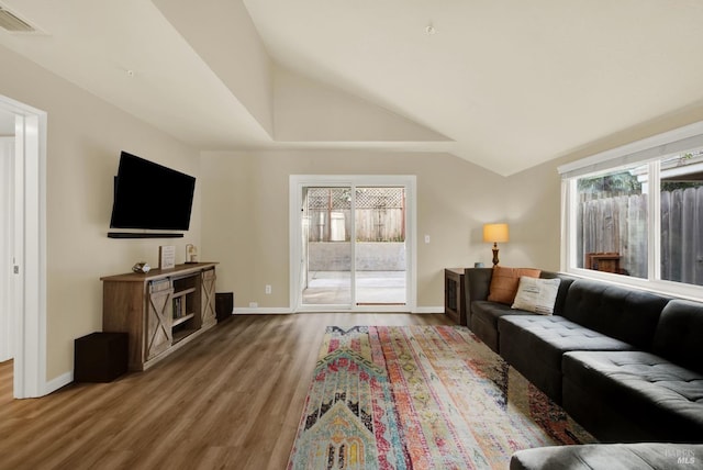 living room with hardwood / wood-style floors and lofted ceiling