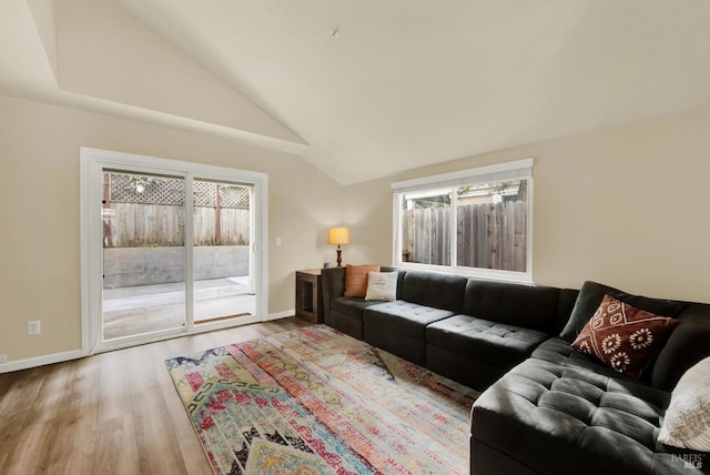 living room featuring vaulted ceiling and hardwood / wood-style floors