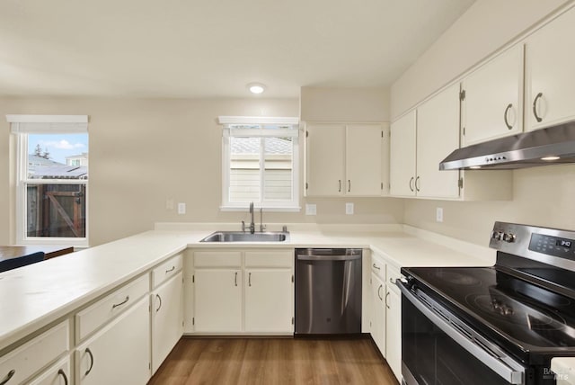 kitchen featuring sink, appliances with stainless steel finishes, white cabinetry, and dark hardwood / wood-style flooring