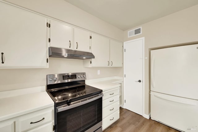 kitchen with white cabinetry, white fridge, wood-type flooring, and stainless steel electric stove