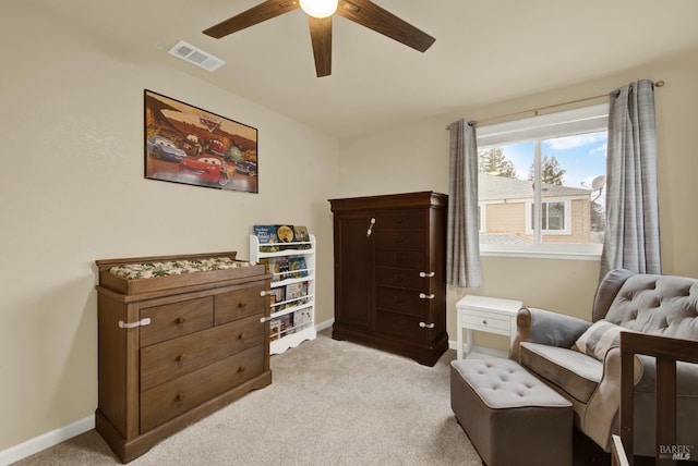 living area featuring ceiling fan and light carpet