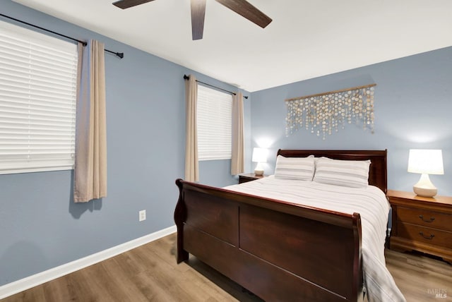 bedroom with ceiling fan and light wood-type flooring