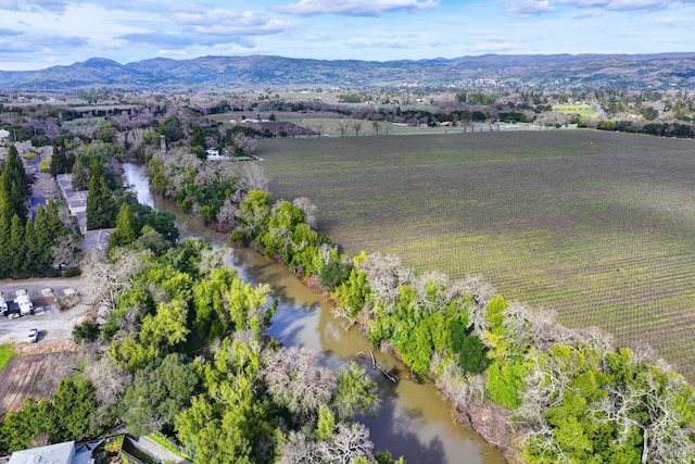 drone / aerial view with a rural view and a water and mountain view