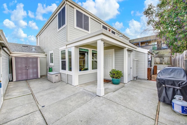 view of front of house featuring a shed and a patio