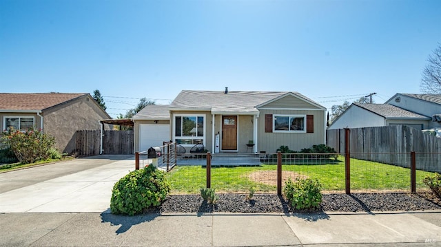 view of front of property with driveway, a fenced front yard, an attached garage, and a front yard