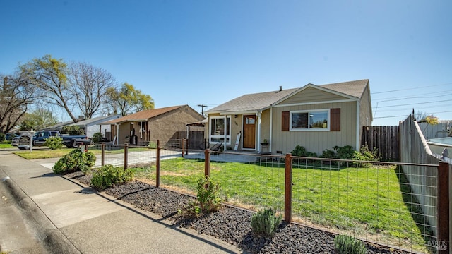 view of front of house with a front lawn and fence private yard