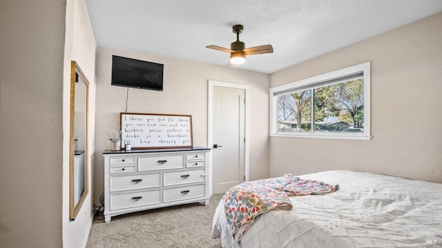 bedroom featuring a ceiling fan and light carpet