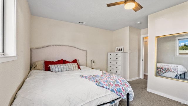 bedroom with baseboards, carpet floors, visible vents, and a ceiling fan