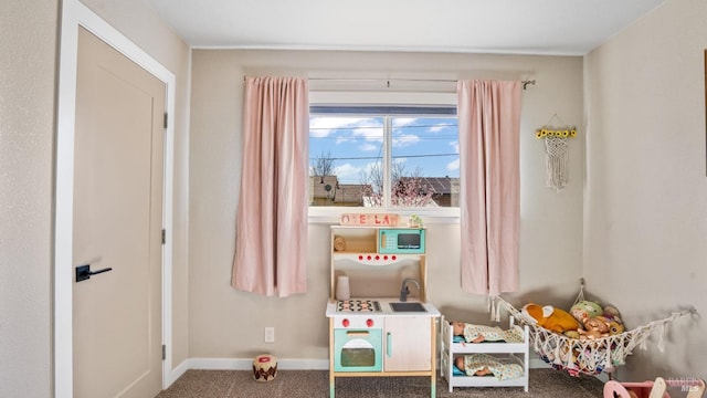 rec room with carpet floors and baseboards