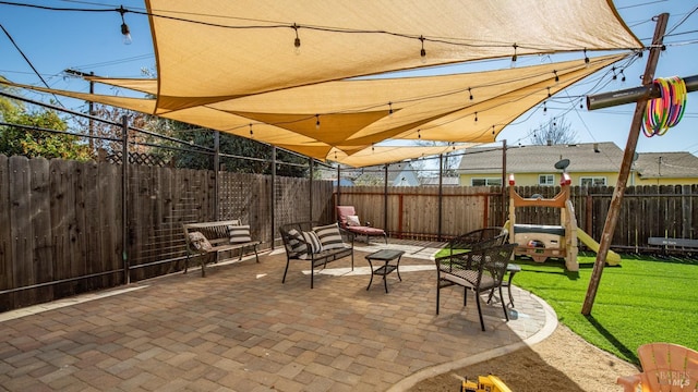 view of patio / terrace featuring a fenced backyard and a playground