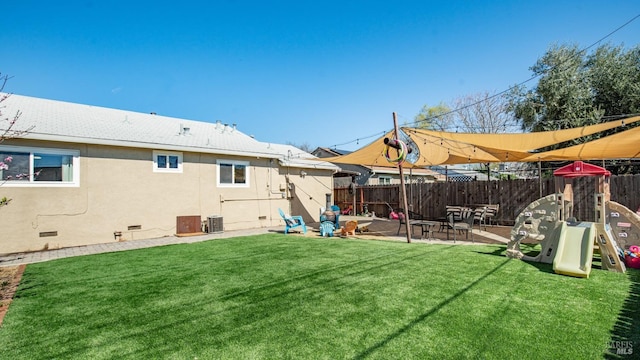 view of yard featuring central air condition unit, fence, and a patio