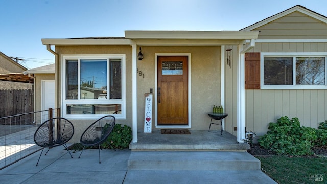 view of exterior entry with fence