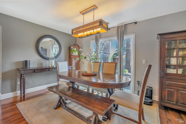 dining area with dark hardwood / wood-style flooring