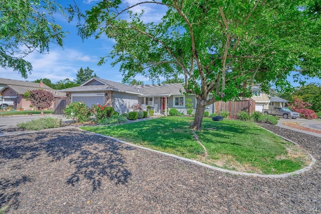 view of front of house featuring a garage and a front yard