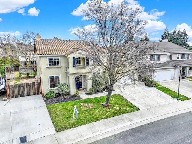 view of front of house with a garage and a front lawn