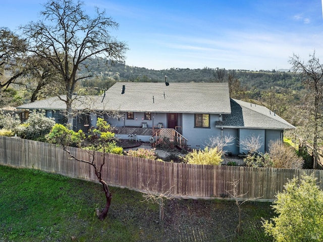 rear view of property featuring a deck