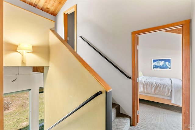 stairs with vaulted ceiling, carpet, and wooden ceiling