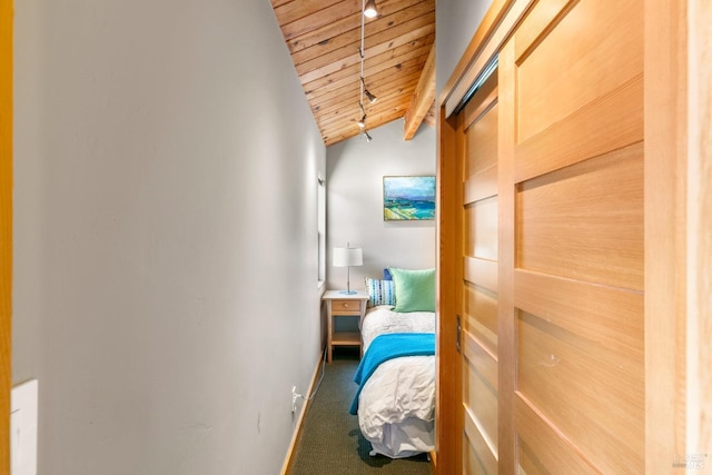 bedroom featuring vaulted ceiling, carpet floors, and wooden ceiling