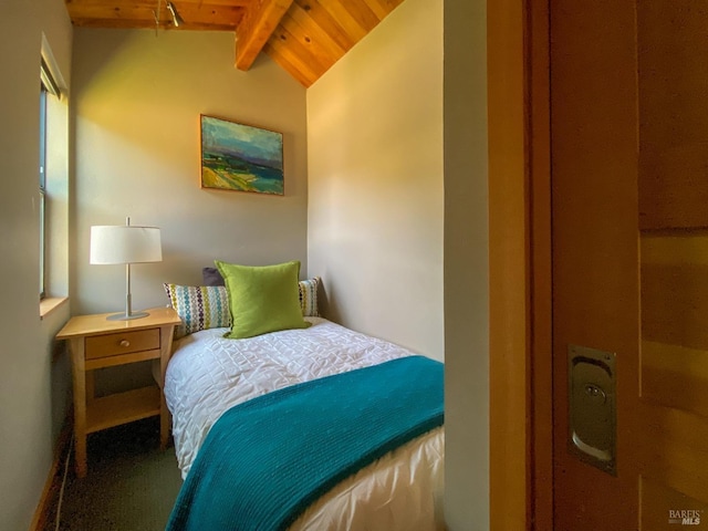 bedroom featuring vaulted ceiling with beams and wood ceiling