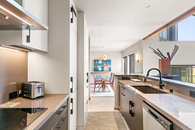 kitchen featuring sink, hanging light fixtures, black electric cooktop, stainless steel dishwasher, and wall chimney range hood