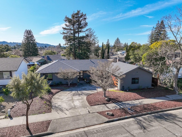 view of front of property with a mountain view and concrete driveway