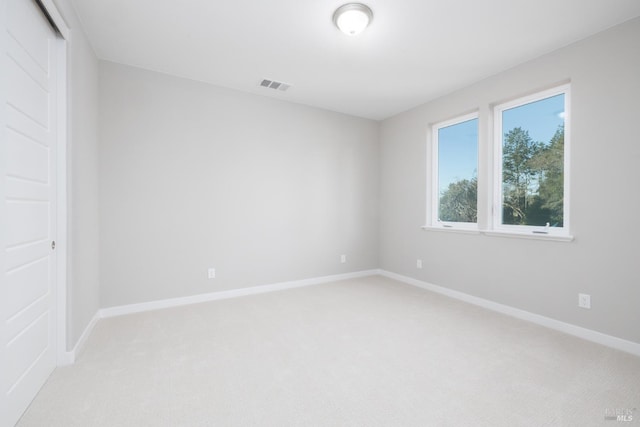 empty room featuring light colored carpet