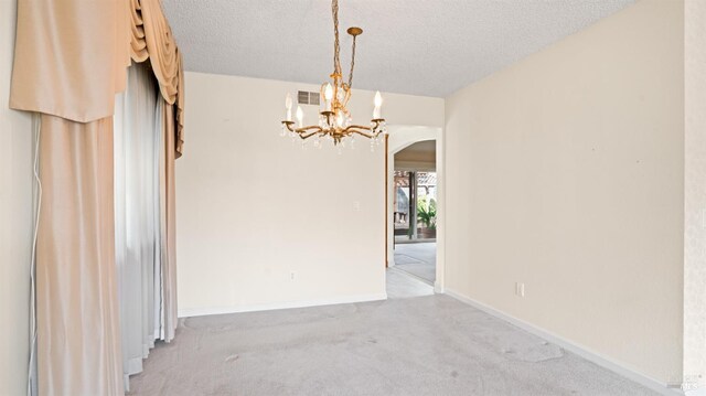 unfurnished room featuring light carpet, visible vents, arched walkways, and a textured ceiling