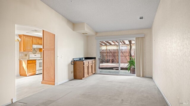 living area featuring light carpet, arched walkways, visible vents, and baseboards