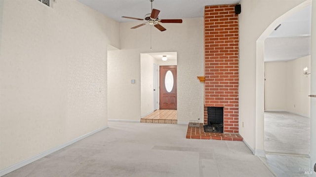 unfurnished living room with ceiling fan, baseboards, visible vents, and light colored carpet