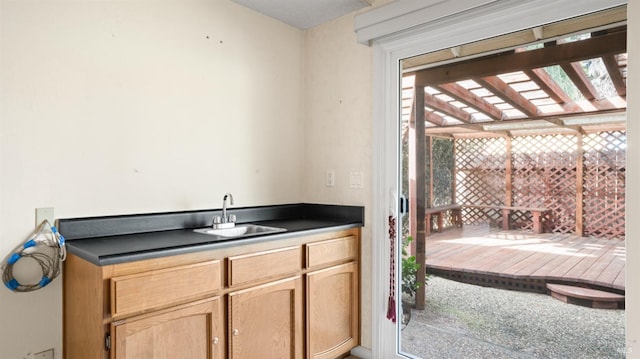 kitchen featuring dark countertops and a sink