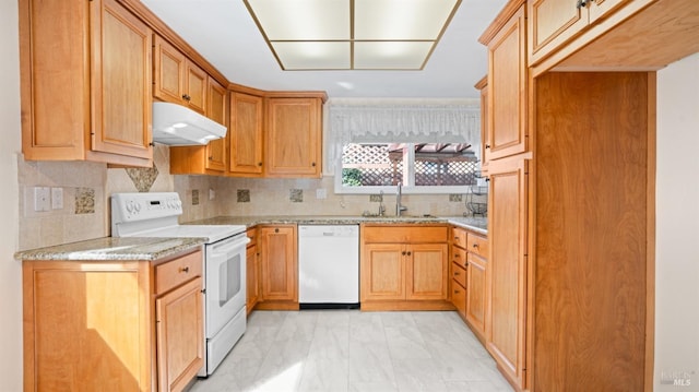 kitchen featuring white appliances, a sink, under cabinet range hood, and decorative backsplash