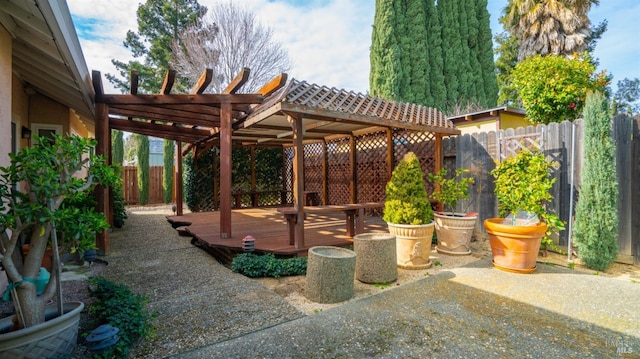 view of patio / terrace featuring fence, a wooden deck, and a pergola